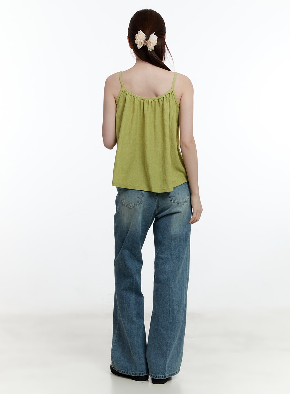 Aleks Relaxed-Fit Flared Jeans CM521 in blue, full back view on model, washed denim with rear patch pockets and bootcut flare, paired with green cami top, casual street style.
