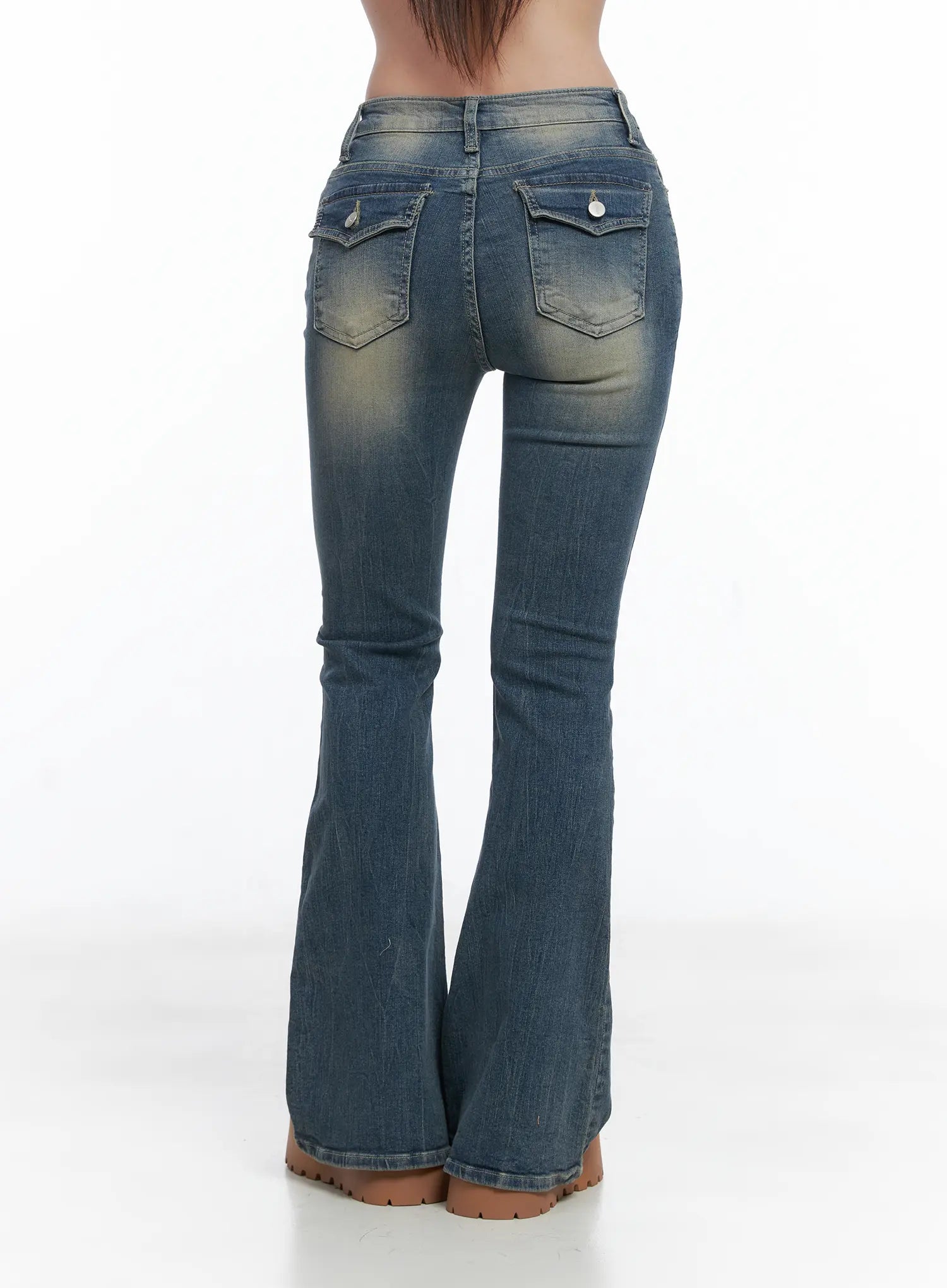 Sloan Vintage Hip Pad Flare Jeans CS502 in dark blue, back product shot waist-to-hem on model, flap back pockets, full flare leg silhouette with vintage wash, raw-edge hem.