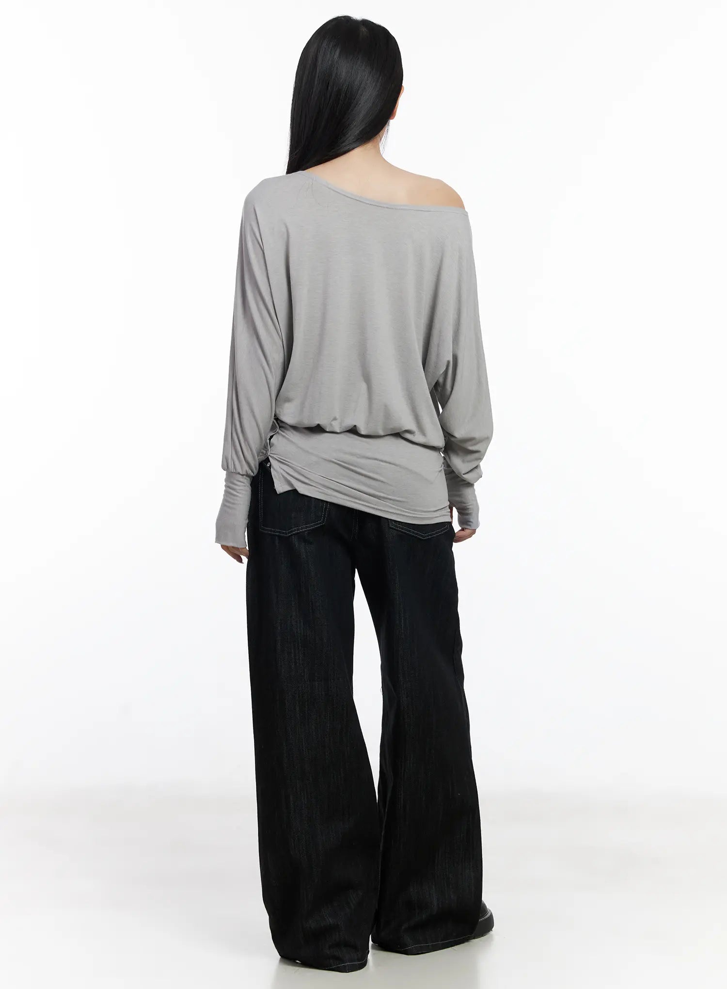 Violet Studded Baggy Jeans CJ530 in black, back full-body view on model styled with grey off-shoulder top, wide-leg cotton denim with contrast stitching showing rear pocket detail, black loafers.