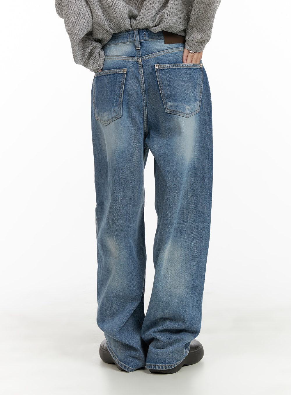 Comfy Wide Fit Baggy Jeans CA408 in blue, full back view on model, wide-leg washed denim with dual back pockets and faded finish, paired with twisted gray knit sweater.