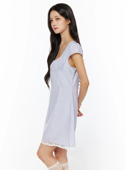 Romantic Floral Lace Trim Mini Dress CU522 in light purple, side view on model, cap sleeve silhouette and A-line flare visible, cream lace trim at hem, lace ankle socks, minimal accessories.