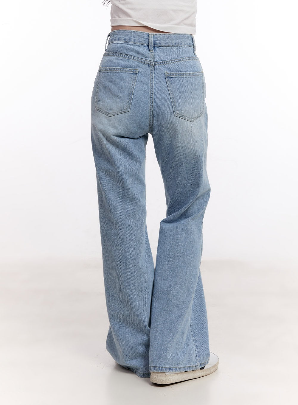 Daniella Relaxed-Fit Flared Jeans CM526 in light blue, back close-up product shot, highlighting back pockets, waistband stitching, and flared leg silhouette in washed cotton denim.