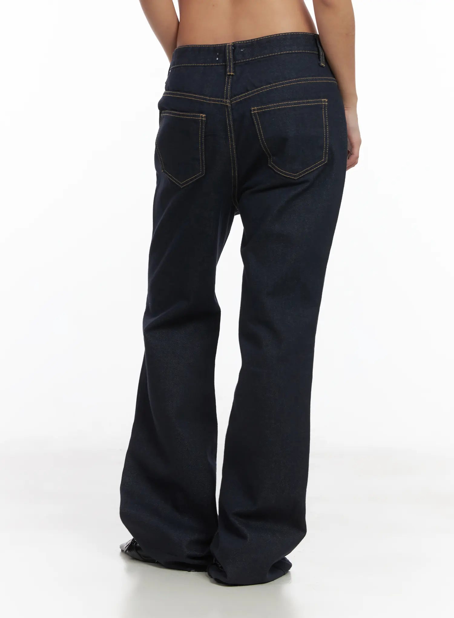 Bunn Non-Fade Eyelet Bootcut Jeans CJ512 in dark blue, back product shot on model, back patch pockets with gold contrast stitching, flared bootcut hem pooling at floor, no top worn.
