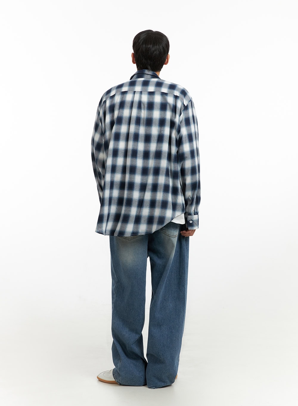 Men's Solid Baggy Jeans IU419 in blue, back full-length on model standing upright, wide baggy leg silhouette with washed indigo finish, paired with plaid overshirt.
