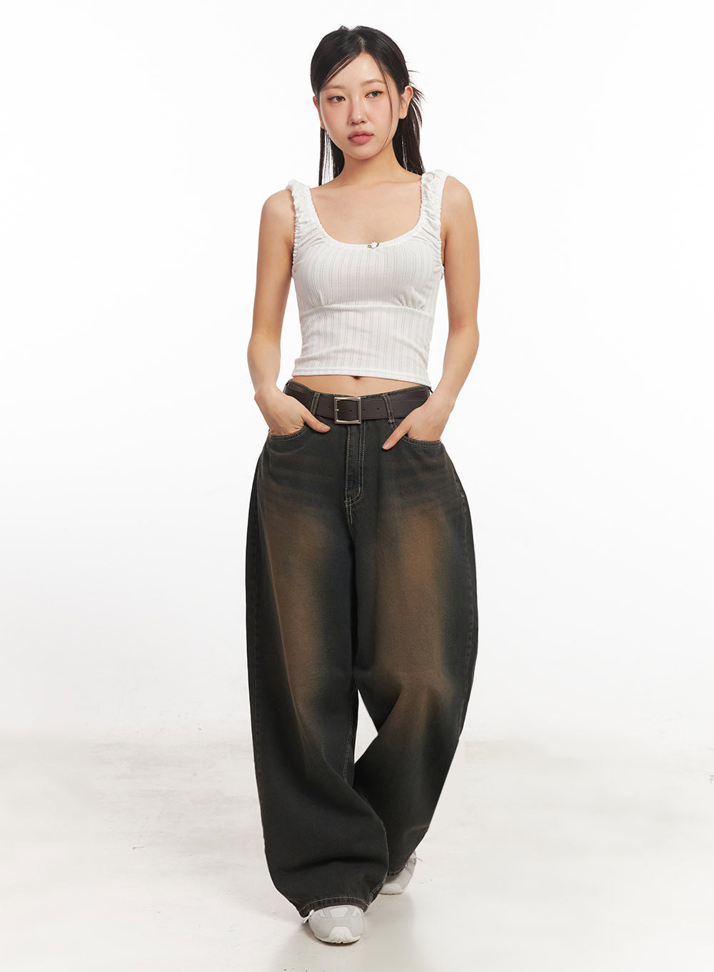 Bethany Vintage Washed Baggy Jeans IA524 in dark brown washed denim, front full-length view on model, baggy wide leg with vintage brown fade, brown belt, styled with white ribbed crop tank top and white sneakers.