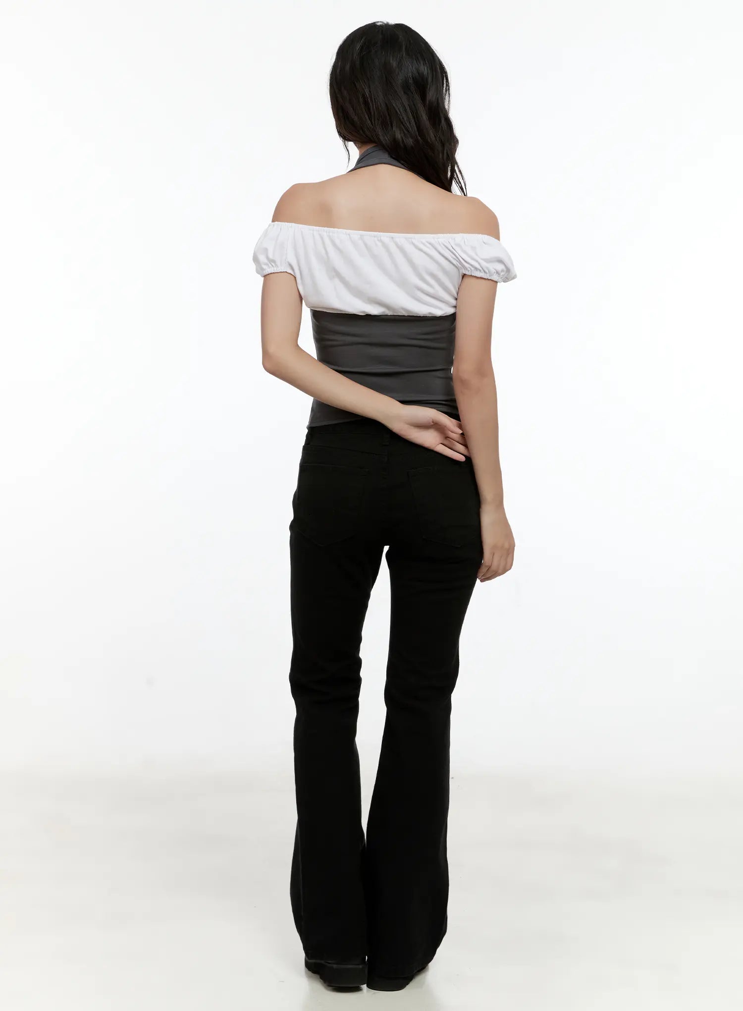 Classic Flare Pants CL531 in black, back full-body shot on model, flare silhouette from waist to hem, paired with white off-shoulder top and black loafers.