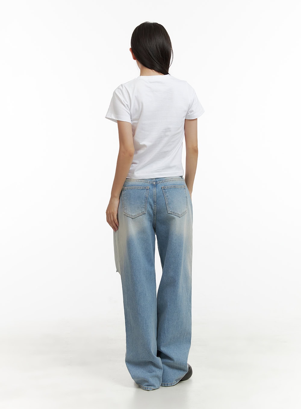 Urban Washed Ripped Baggy Jeans CU405 in Blue, full-body back view on model, wide baggy silhouette with washed light blue denim, back pockets visible, paired with white crop tee.