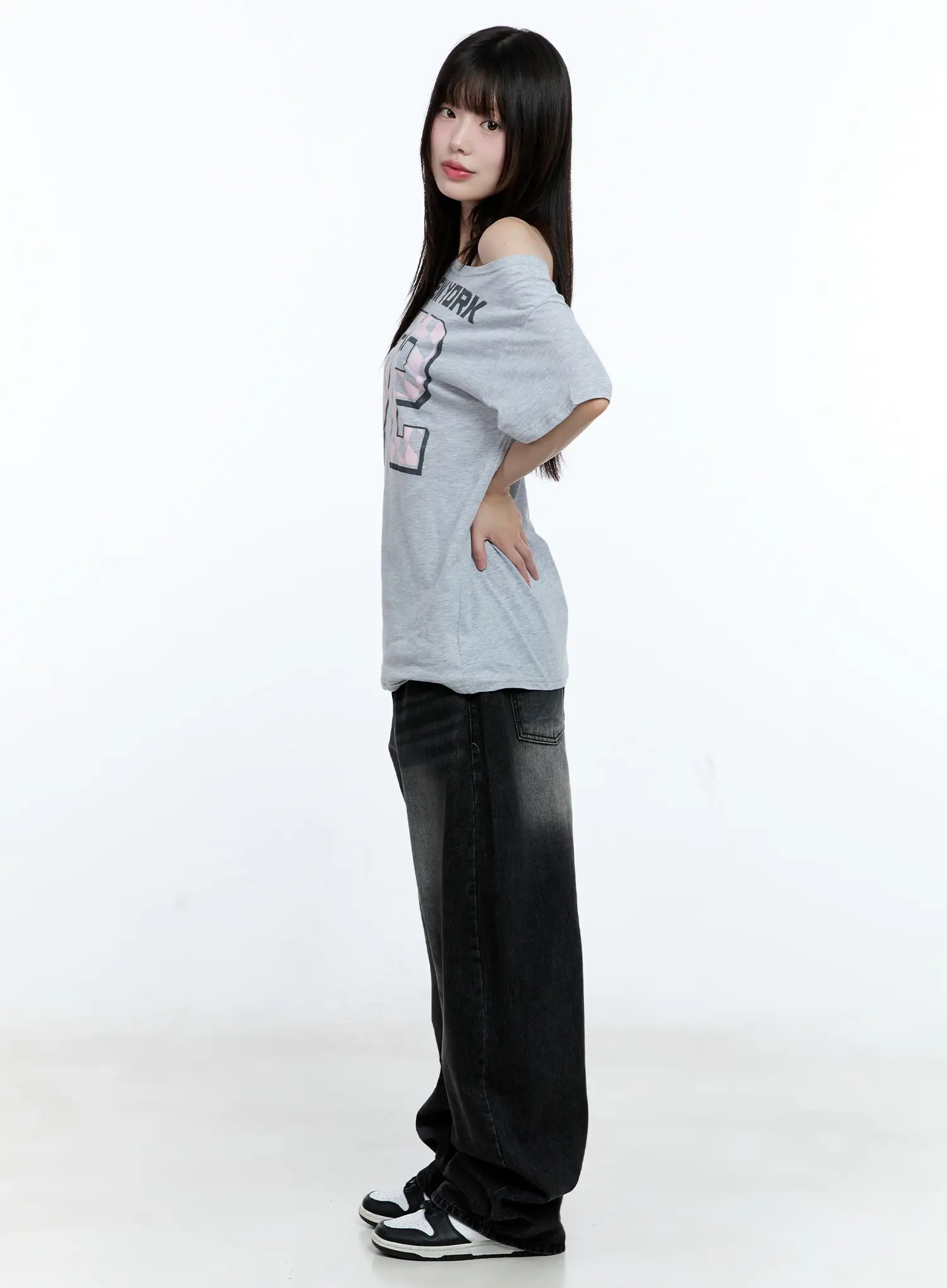 Gayeon Washed Wide-Leg Jeans CG507 in black, side full-body shot on model, showing wide-leg length pooling at floor, washed gradient denim, paired with off-shoulder tee.
