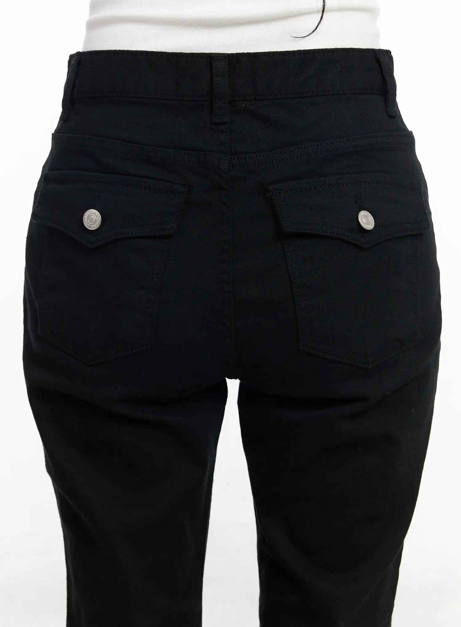 Ellis High-Waist Bootcut Jeans IJ529 in black, close-up back pocket detail on model, dual patch pockets with silver snap buttons and clean topstitching on solid black denim.