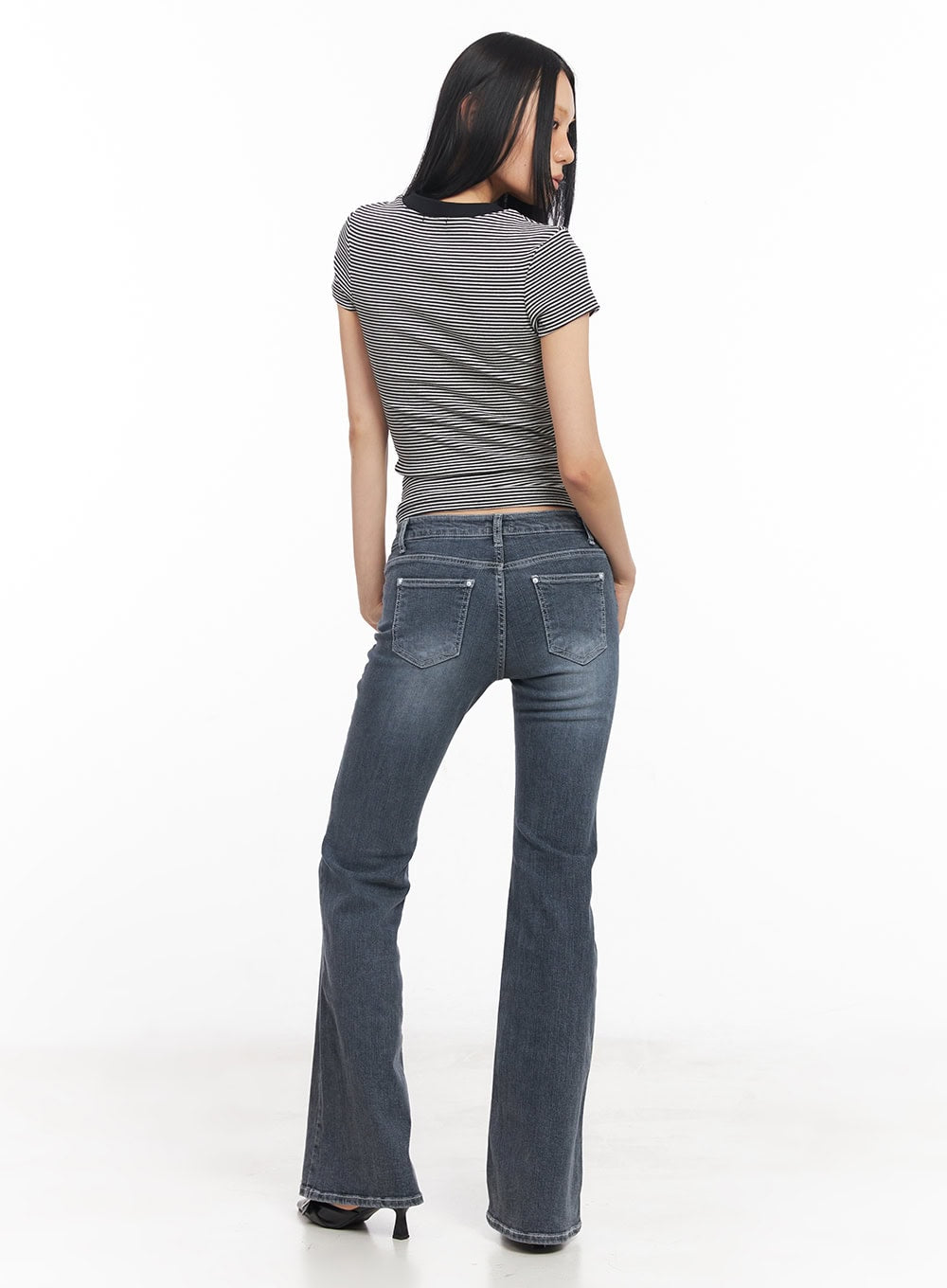 Nadeline Slim Bootcut Jeans CY528 in dark gray, full back view on model, highlighting rear patch pockets with silver rivets and bootcut hem flare, washed denim, paired with striped crop top.