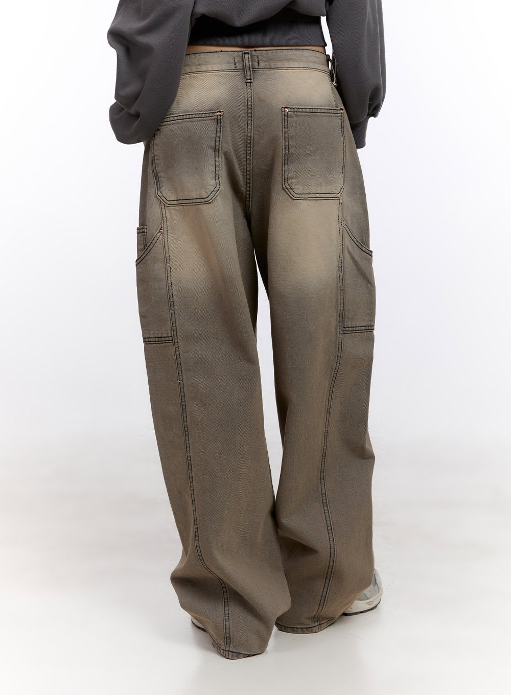 Sara Stitched Pocket Baggy Jeans CF512 in Beige, back mid-length close-up on model, washed denim featuring oversized patch back pockets and contrast topstitching on wide-fit leg.