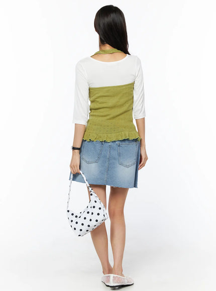 Casual Denim Mini Skirt CU522 in light blue, back full-length on model, dual back pockets and frayed hem visible, styled with green knit vest over white tee and polka-dot bag.