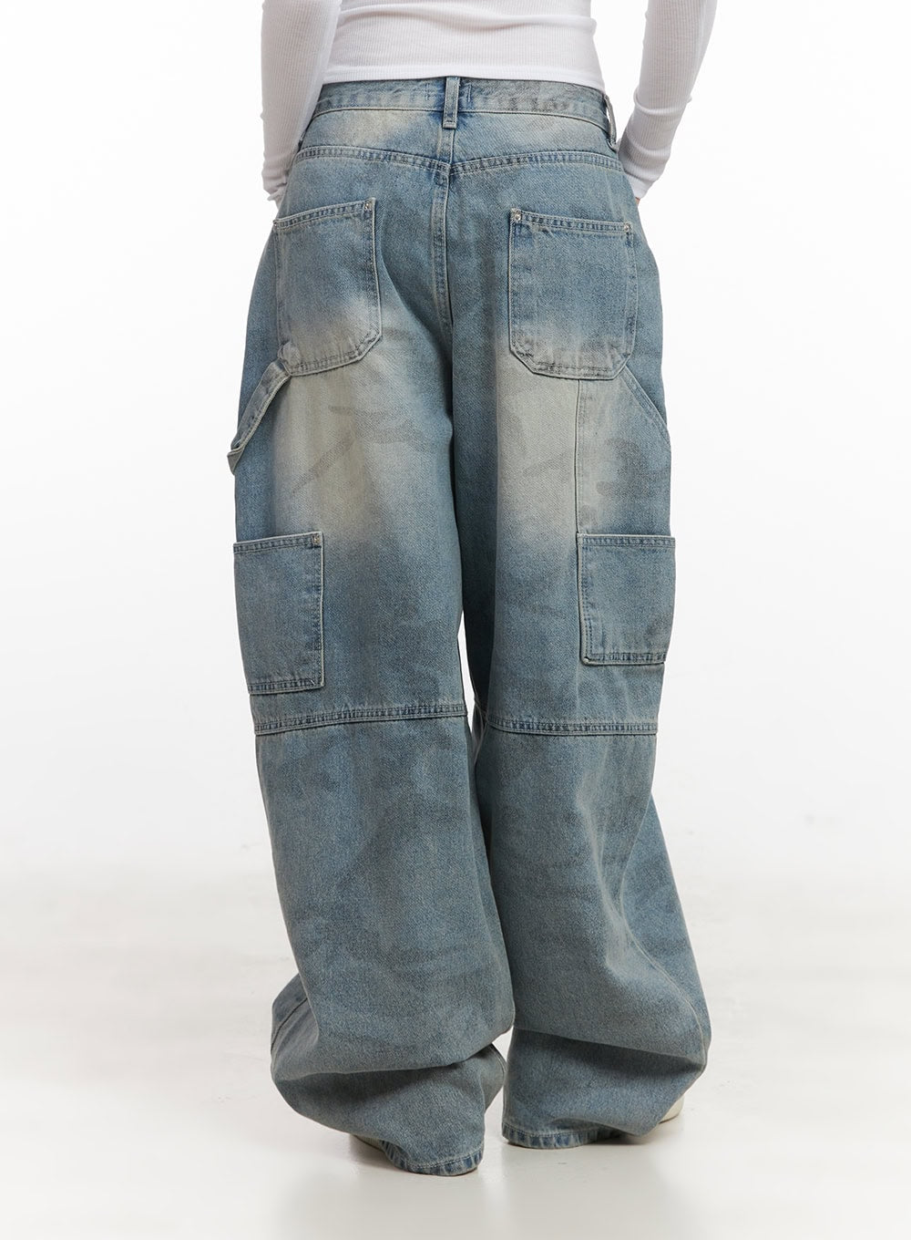 Abigail Camo-Print Carpenter Baggy Jeans CJ528 in blue, back view waist-down on model, two back patch pockets and large carpenter pockets visible, washed camo cotton denim, wide-leg hem.
