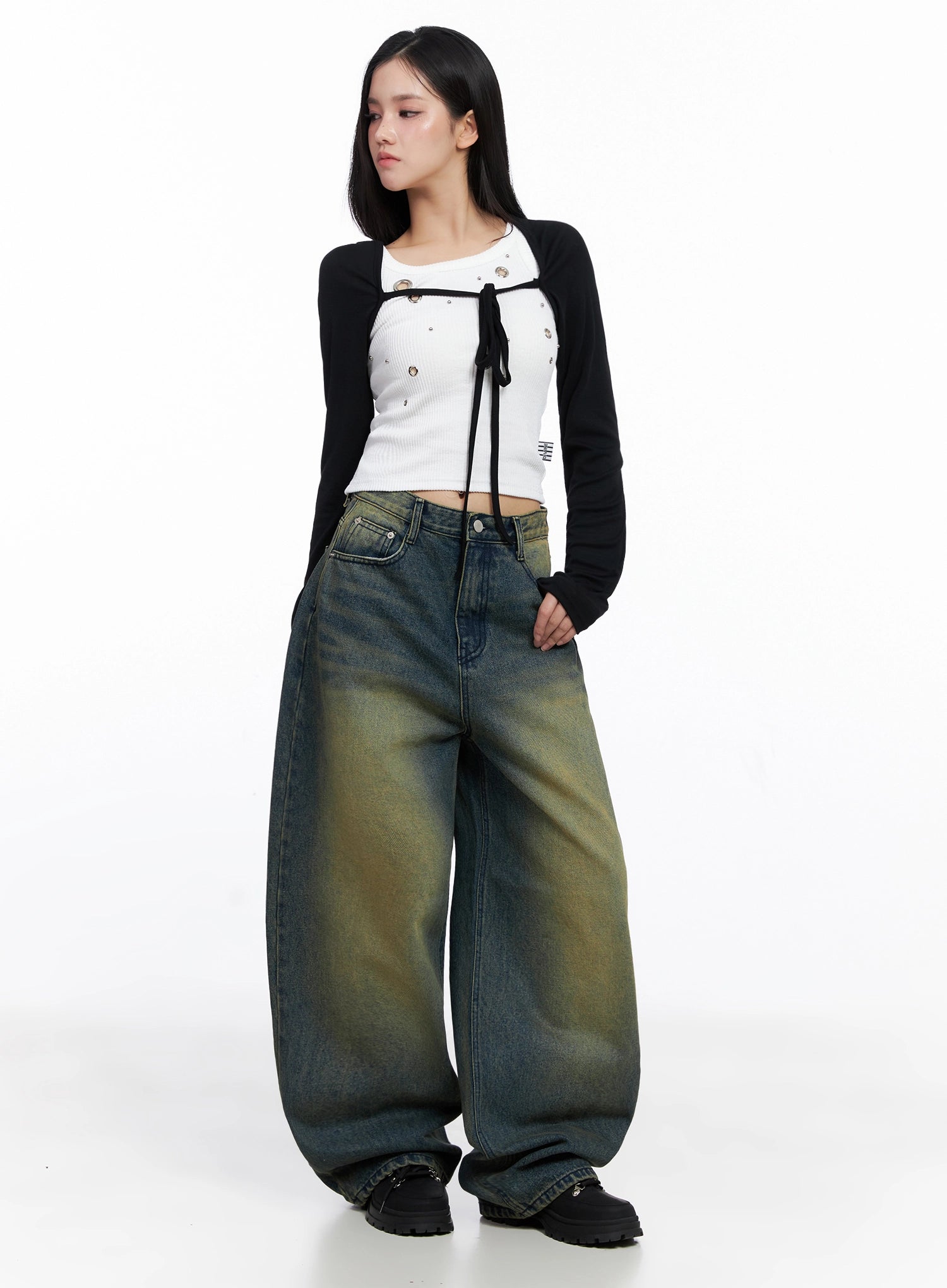 Elora Washed Baggy Jeans IS525 in dark blue, three-quarter front view on model, oversized wide-leg washed denim with yellow-green fade, paired with white ribbed crop and black bolero.