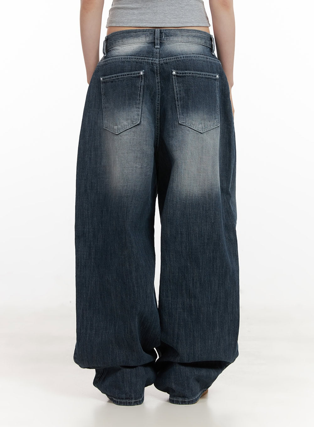 Alison Destroyed Baggy Jeans CJ523 in dark blue, back view on model without top shown, featuring dual back patch pockets with washed fade and voluminous wide-leg pooling hem.