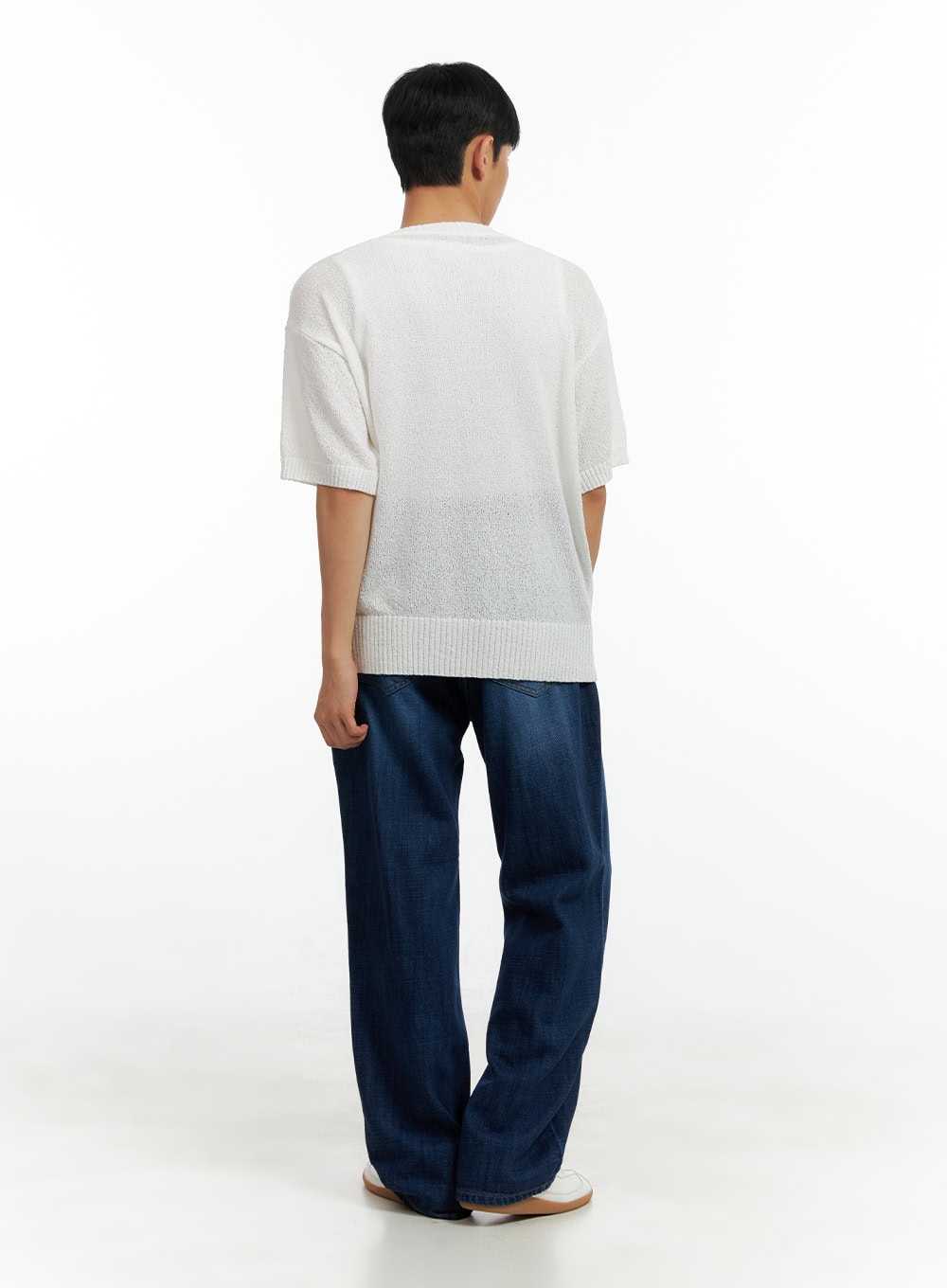 Men's Washed Cotton Denim Jeans CL429 in dark blue, back full-body view on male model, wide-leg silhouette, washed denim, paired with white knit top and white sneakers.