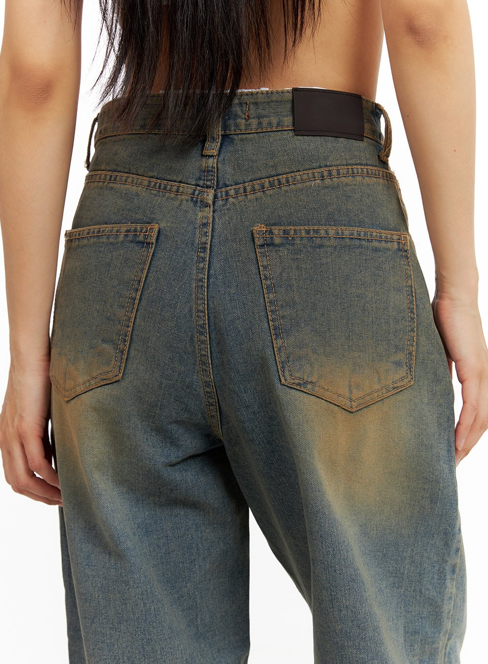 Low Rise Straight Jeans CA424 in dark blue, back close-up on model, dual back pockets with amber stitching, dark leather patch, and vintage washed denim texture.