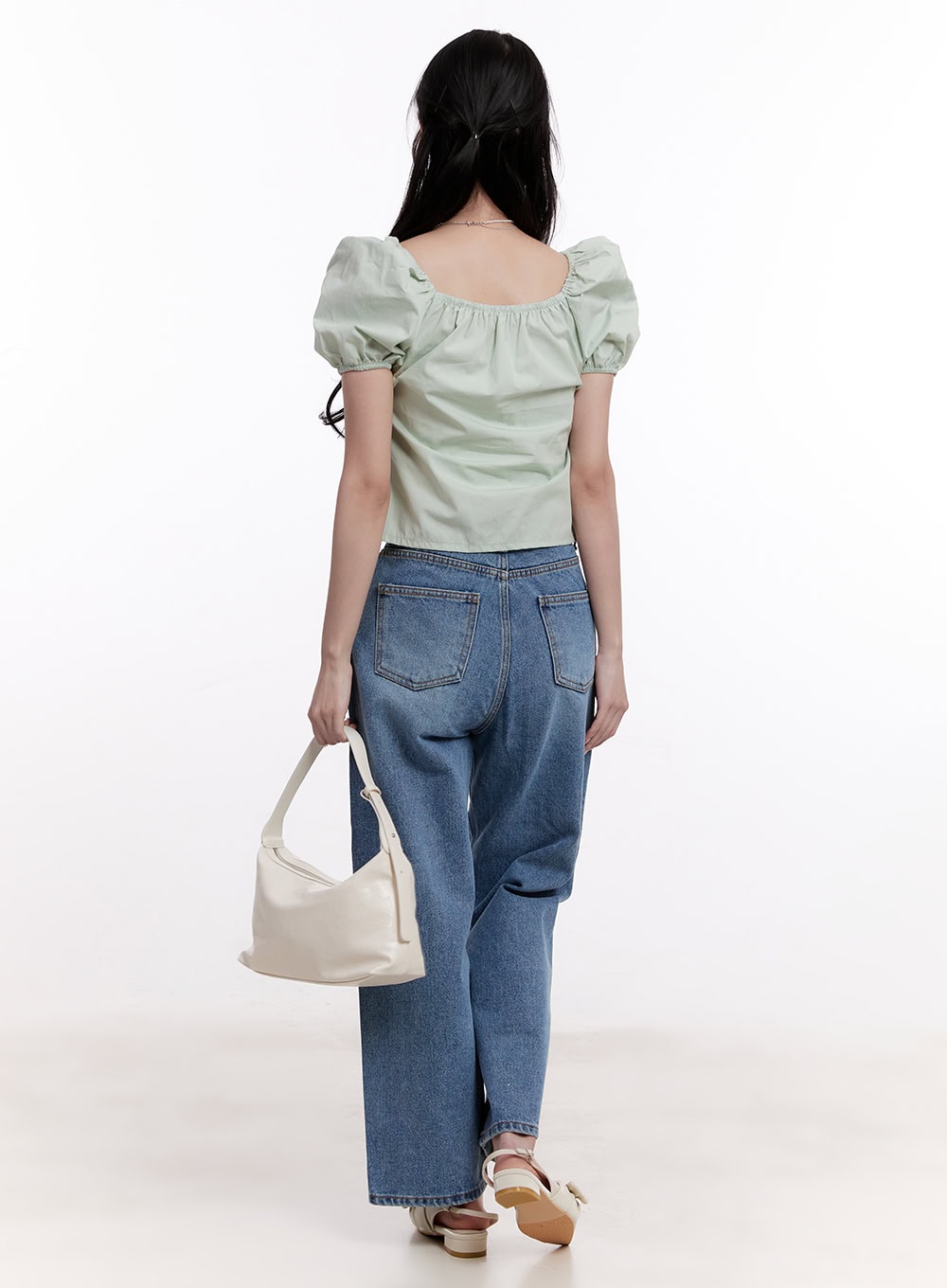 Jamie Comfy Straight-Fit Jeans CM526 in mid-blue wash, full back view on model walking, straight-fit washed denim with rear pocket detail, styled with sage green puff-sleeve top and cream bag.