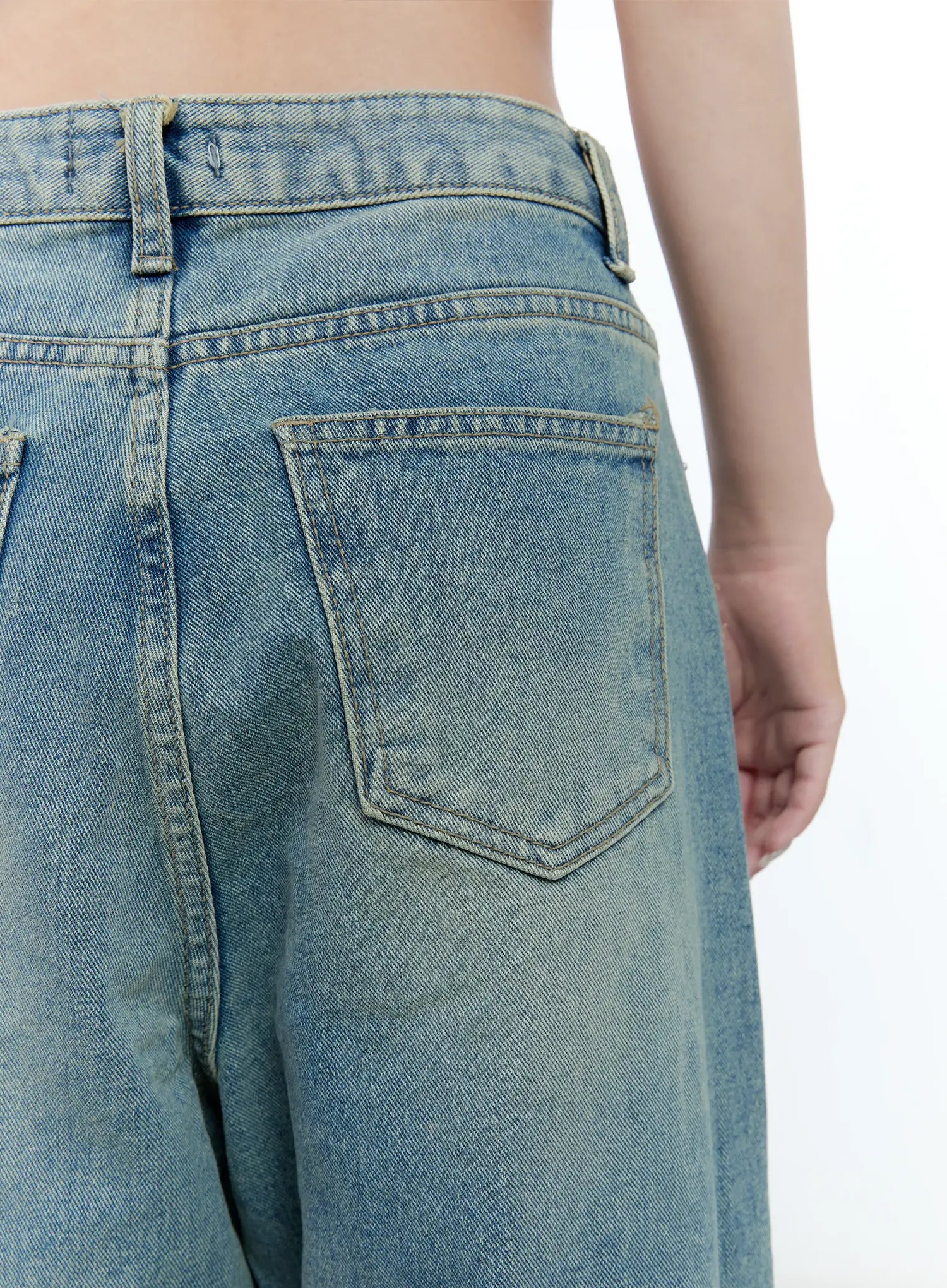 Haeun Wide-Leg Denim Jeans CG501 in blue, close-up of back waistband and rear pocket, highlighting washed denim texture, double-stitch pocket detail, and belt loops.