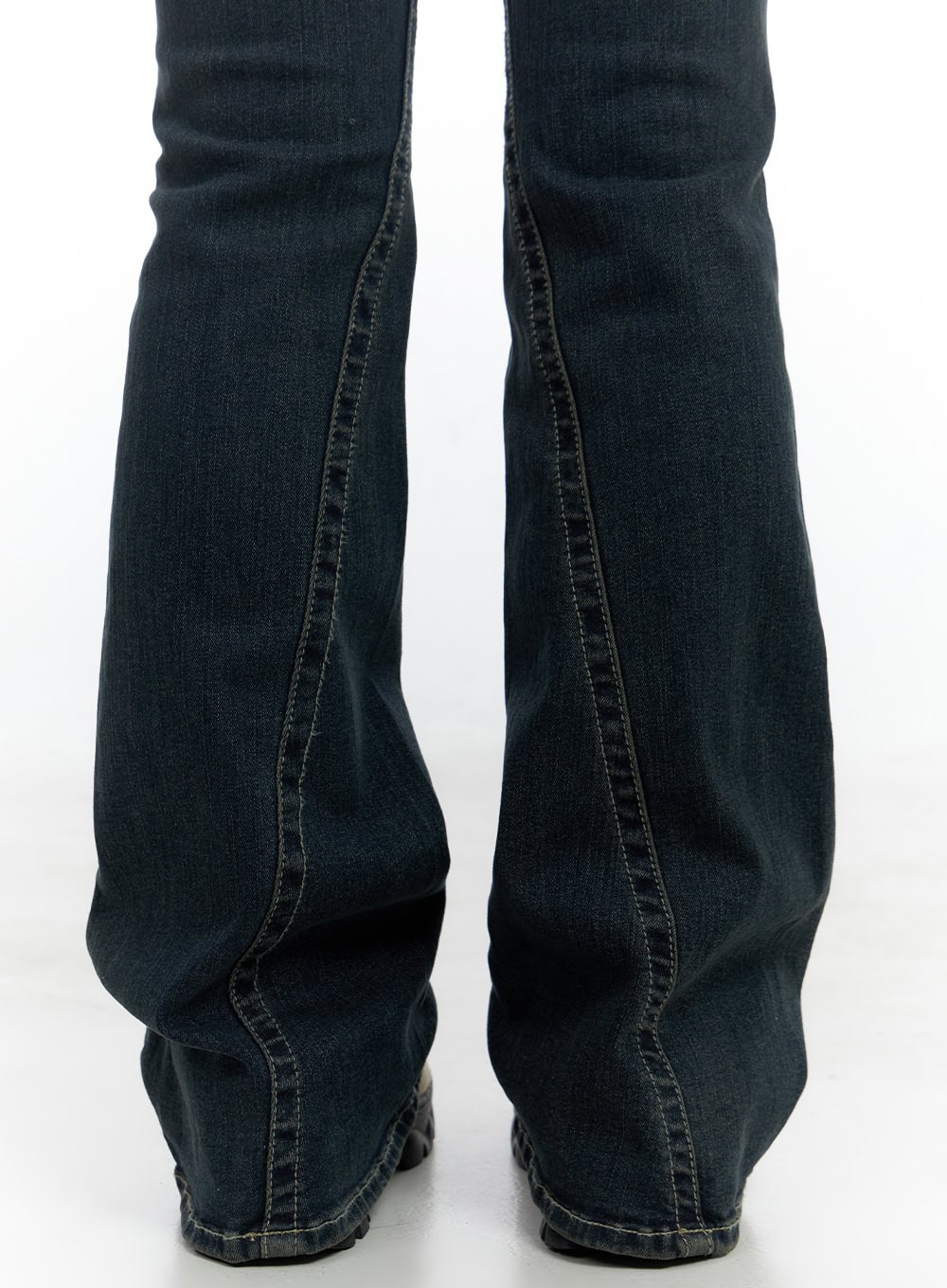 Aspen SlimFit Washed Bootcut Denim Jeans CS424 in dark blue, rear detail close-up of lower leg, showing center back seam, bootcut flare silhouette, and cotton-spandex denim weave texture.