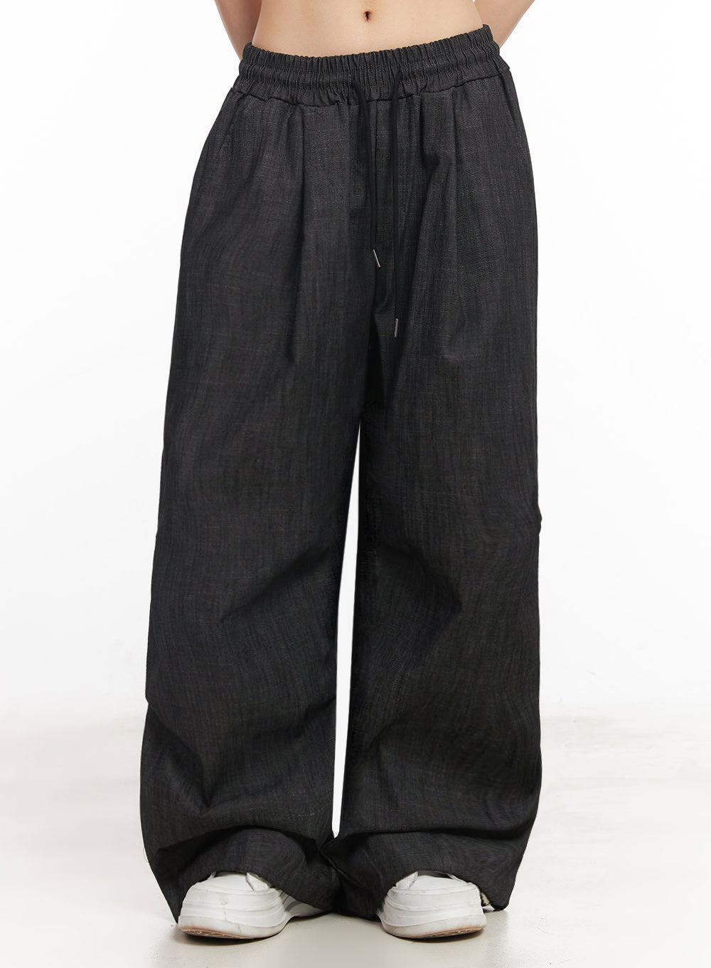 Pintuck Denim Sweatpants IY529 in black, close-up front waist-to-hem shot on model, elastic banded waist with visible drawstring, pintuck pleats, wide cotton denim leg with pooled hem.