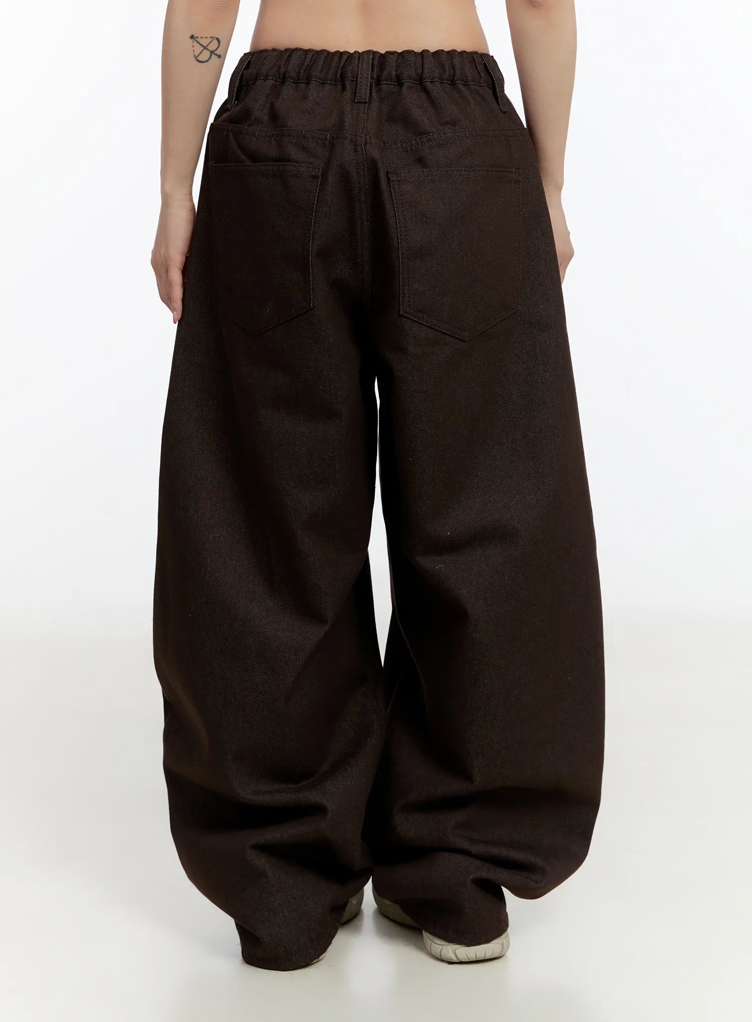 Emely Wide Leg Jeans CN524 in dark brown, full back view on model, elasticated banded waistband, oversized wide-leg silhouette with patch pockets, heavy denim fabric pooling at hem.