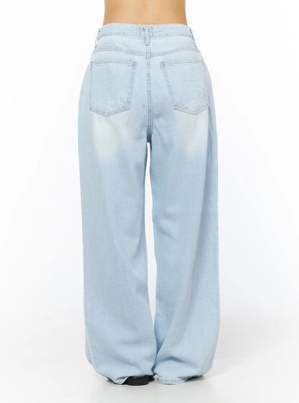 Rina Washed Wide-Leg Jeans CU522 in light blue, back view on model (waist-down), showing dual back pockets, wide-leg cut, and light wash finish.