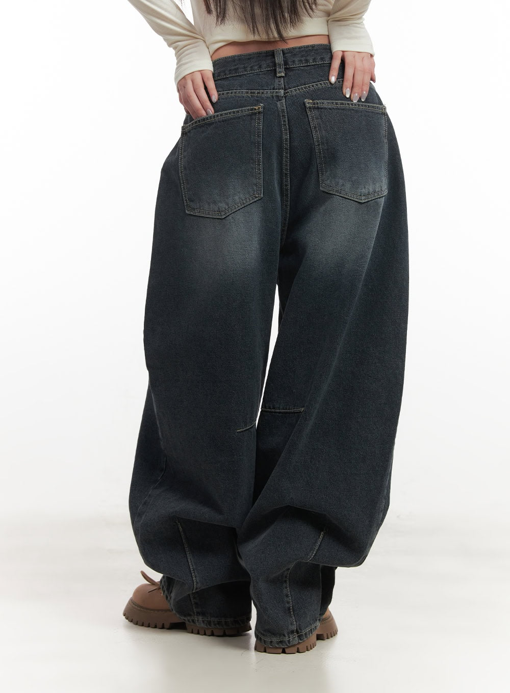 Giselle Stitched Balloon-Fit Jeans CF526 in dark blue, rear close-up on model emphasising both back pockets, contrast topstitching, and dramatic ballooned hem pooling over boots.