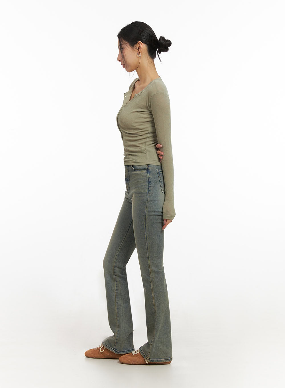 Cathy Washed Slim-Fit Flared Jeans IJ503 in vintage blue, side profile full-length on model, slim fit through hip and thigh with subtle flare, washed denim, styled with olive long-sleeve top.