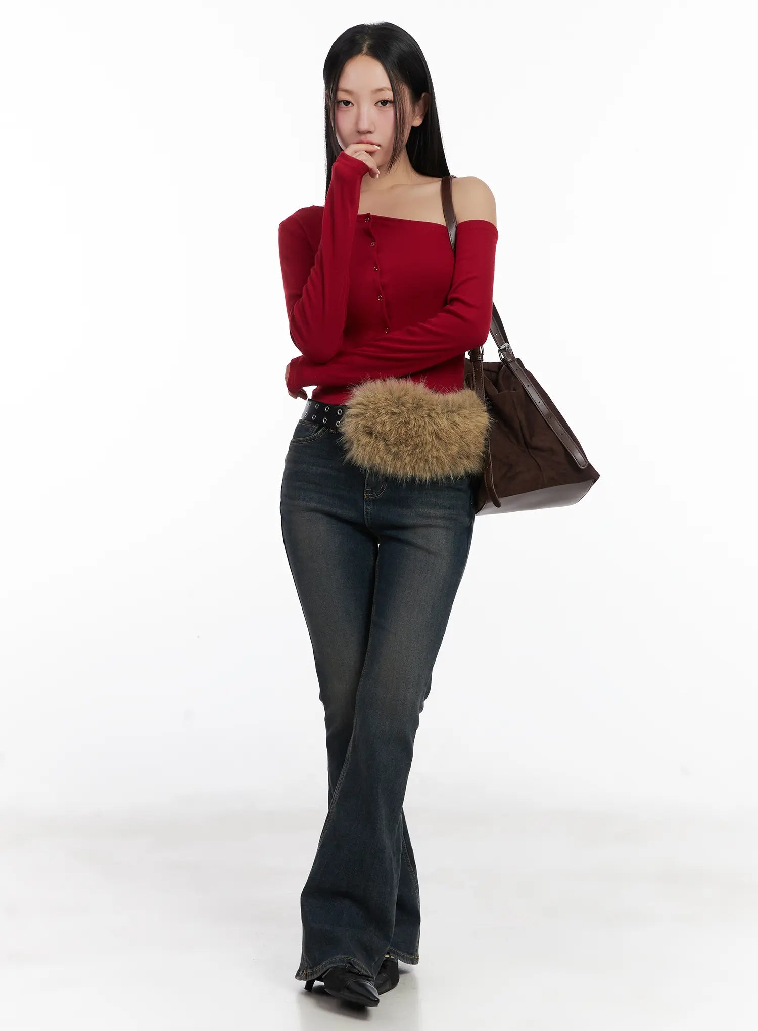 Jay Dark-Wash Bootcut Jeans CD501 in dark blue, full-body editorial shot on model, styled with red off-shoulder top, fur belt bag, and brown leather tote, casual feminine look.