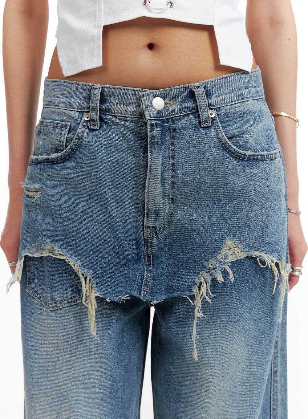 Layered Wide Leg Jeans CA430 in Blue, front detail close-up on model, macro view of destroyed frayed raw-hem skirt overlay layer, heavy fringe distressing across hip seam, washed blue denim.