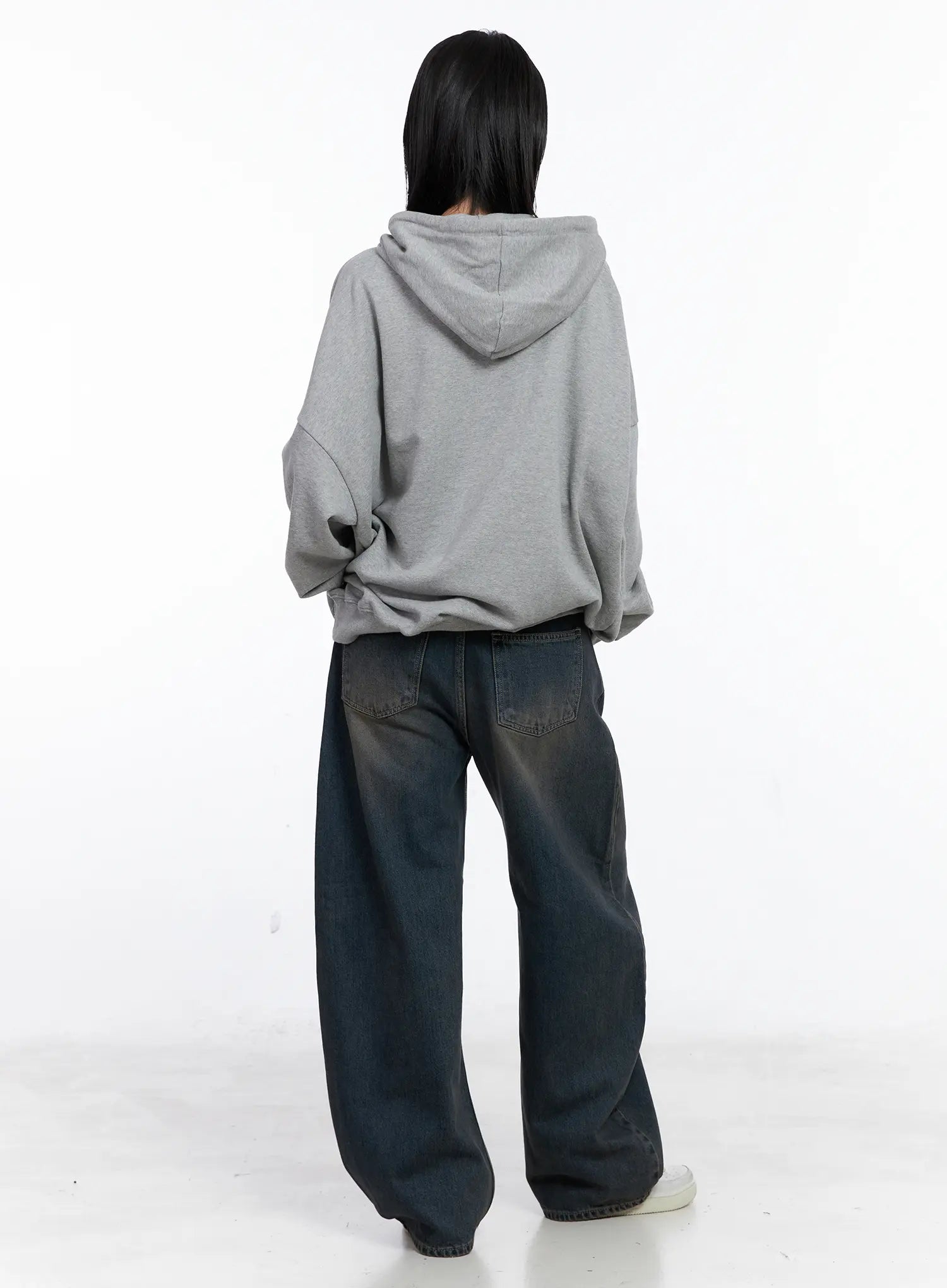 Ocean Faded Balloon Fit Jeans CS510 in washed dark indigo, full back view on model, wide balloon leg and long length shown, layered with oversized grey hoodie and white sneakers.