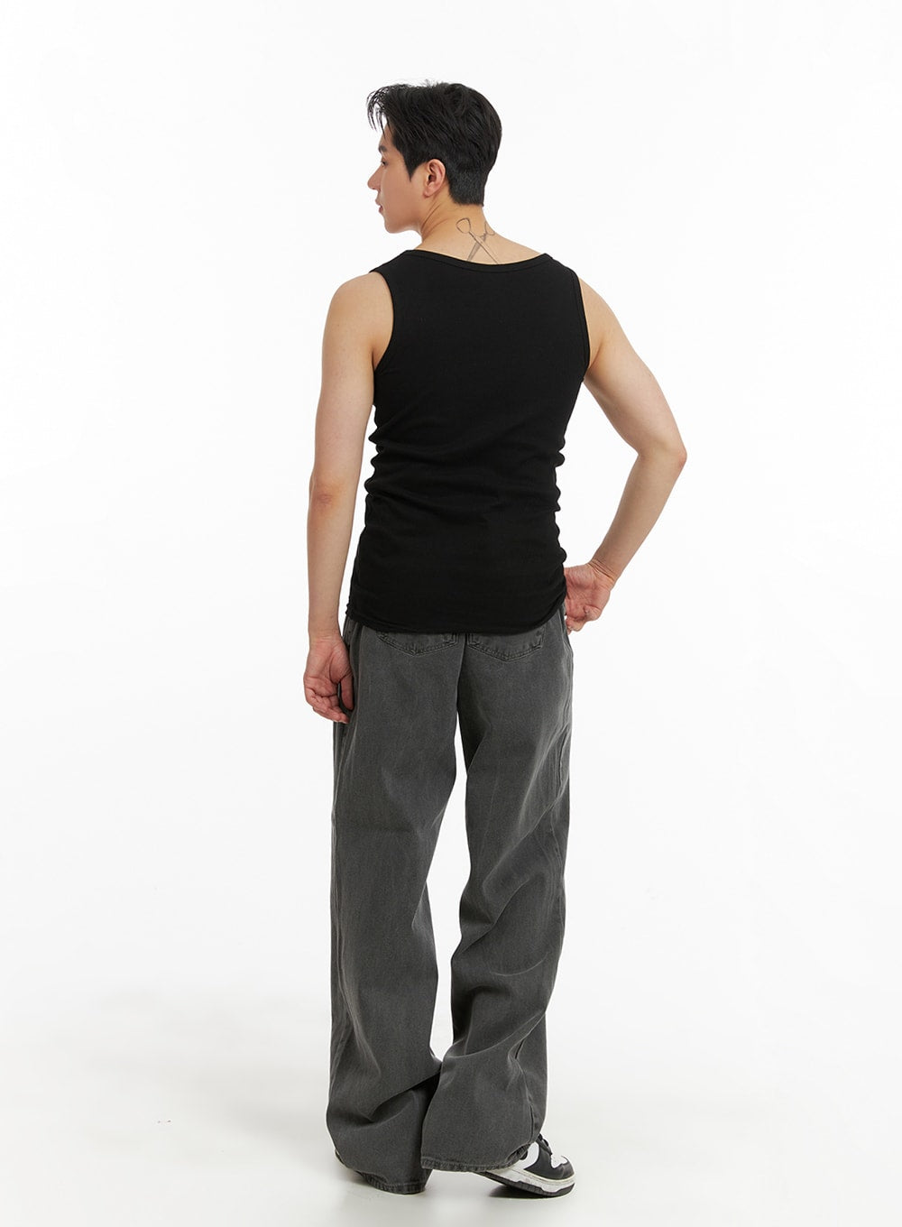 Men's Classic Baggy Fit Jeans IA401 in washed grey, back full-length shot on model in black tank, showing wide-leg drape, back pockets, and hem break at sneakers.