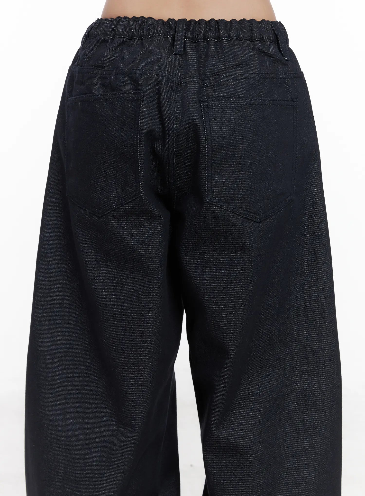 Solana Unwashed Wide-Leg Jeans CN514 in dark indigo, back waist close-up, elastic ruched waistband detail, dual back patch pockets on unwashed dark denim.