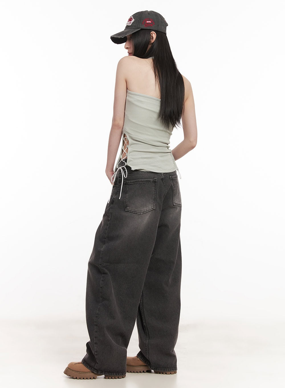 Dianna Baggy Jeans CM518 in dark gray, three-quarter back angle on model turned slightly, showing washed gradient denim and roomy wide-leg hem pooling at loafers.