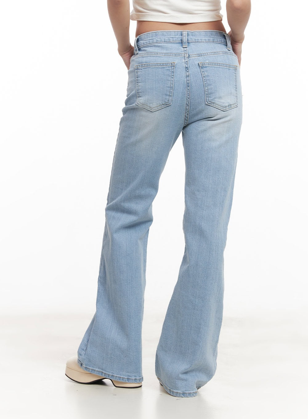 Suzy Slim-Fit Bootcut Jeans CM505 in light blue, close back view on model, highlighting dual rear pockets and bootcut flare, light washed denim texture, waistband detail visible.