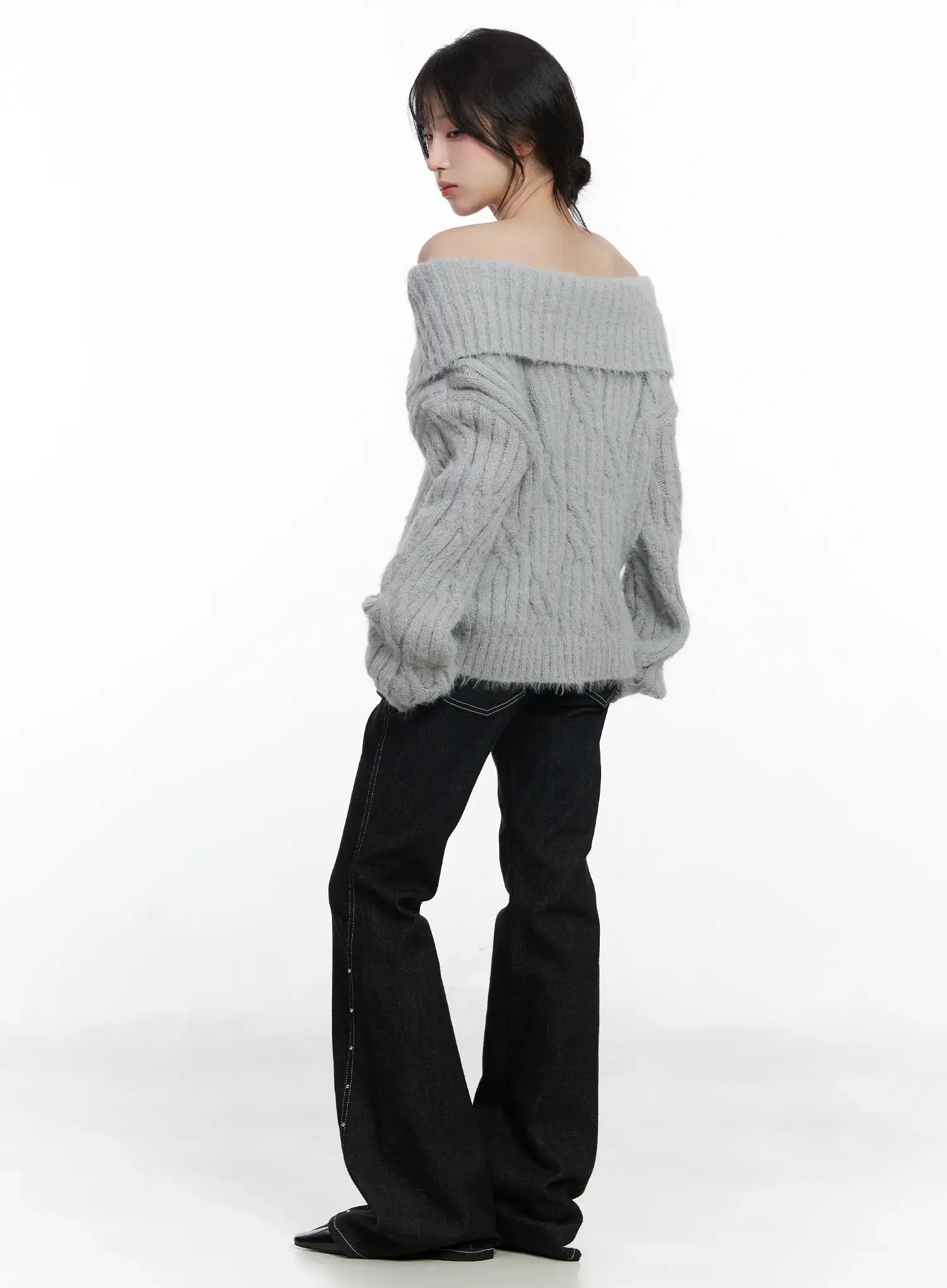 Dahy Stylish High-Waisted Bootcut Jeans CJ526 in black, three-quarter back view on model wearing grey off-shoulder sweater, bootcut flare hem and side stud seam detail highlighted.