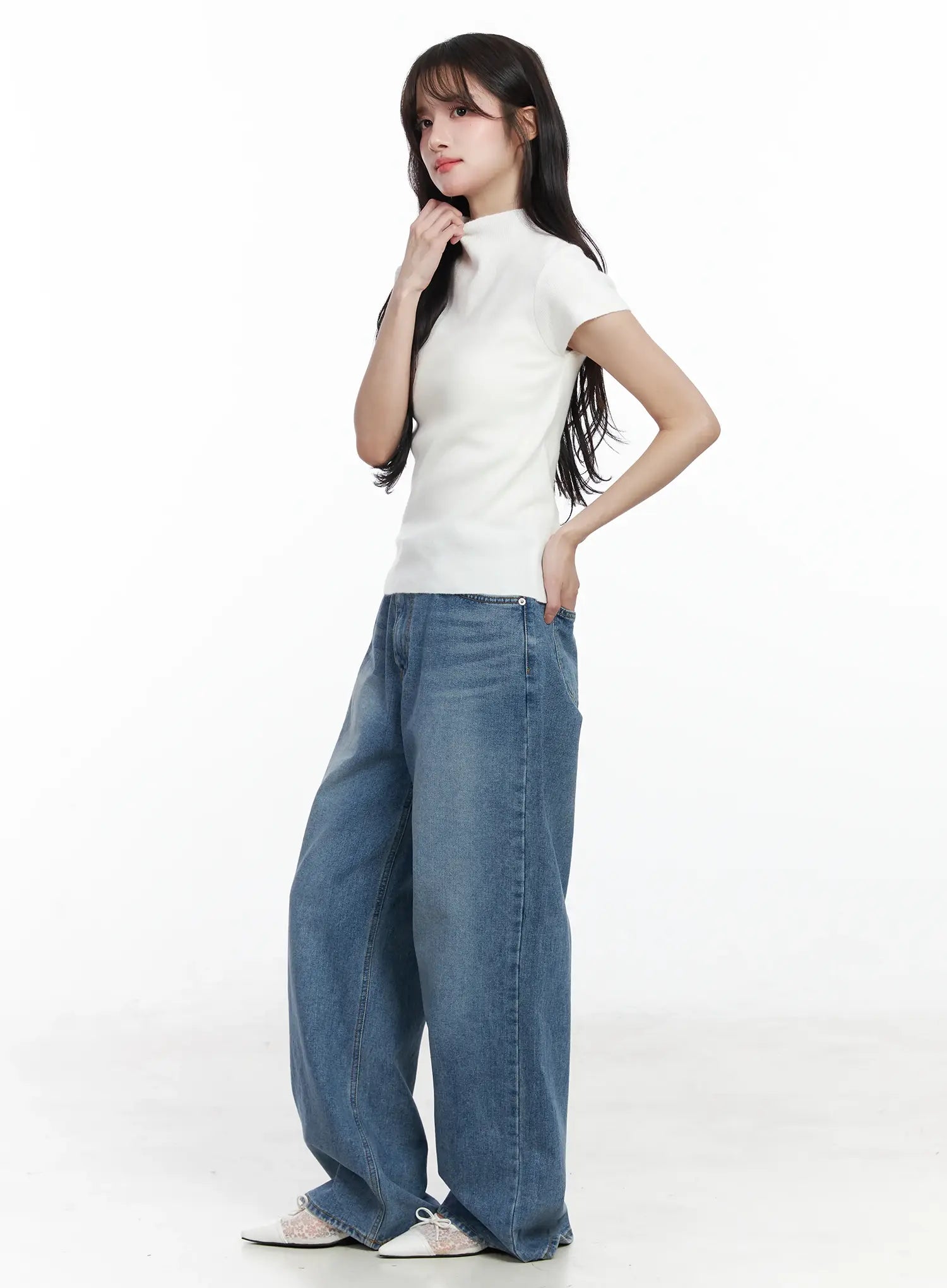 Ensley Wide Leg Jeans IJ529 in blue, three-quarter side outfit shot on model, washed wide leg silhouette paired with white ribbed crop top, relaxed casual look.