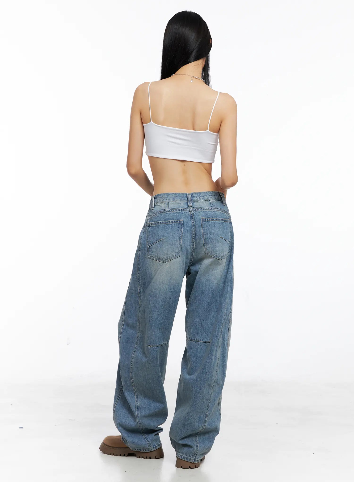 Dakota Relaxed Fit Vintage Wash Jeans CS511 in blue, back full-length studio shot on model, wide-leg denim with back patch pockets, curved yoke seam, knee panel stitch, and vintage fade, white cami top.