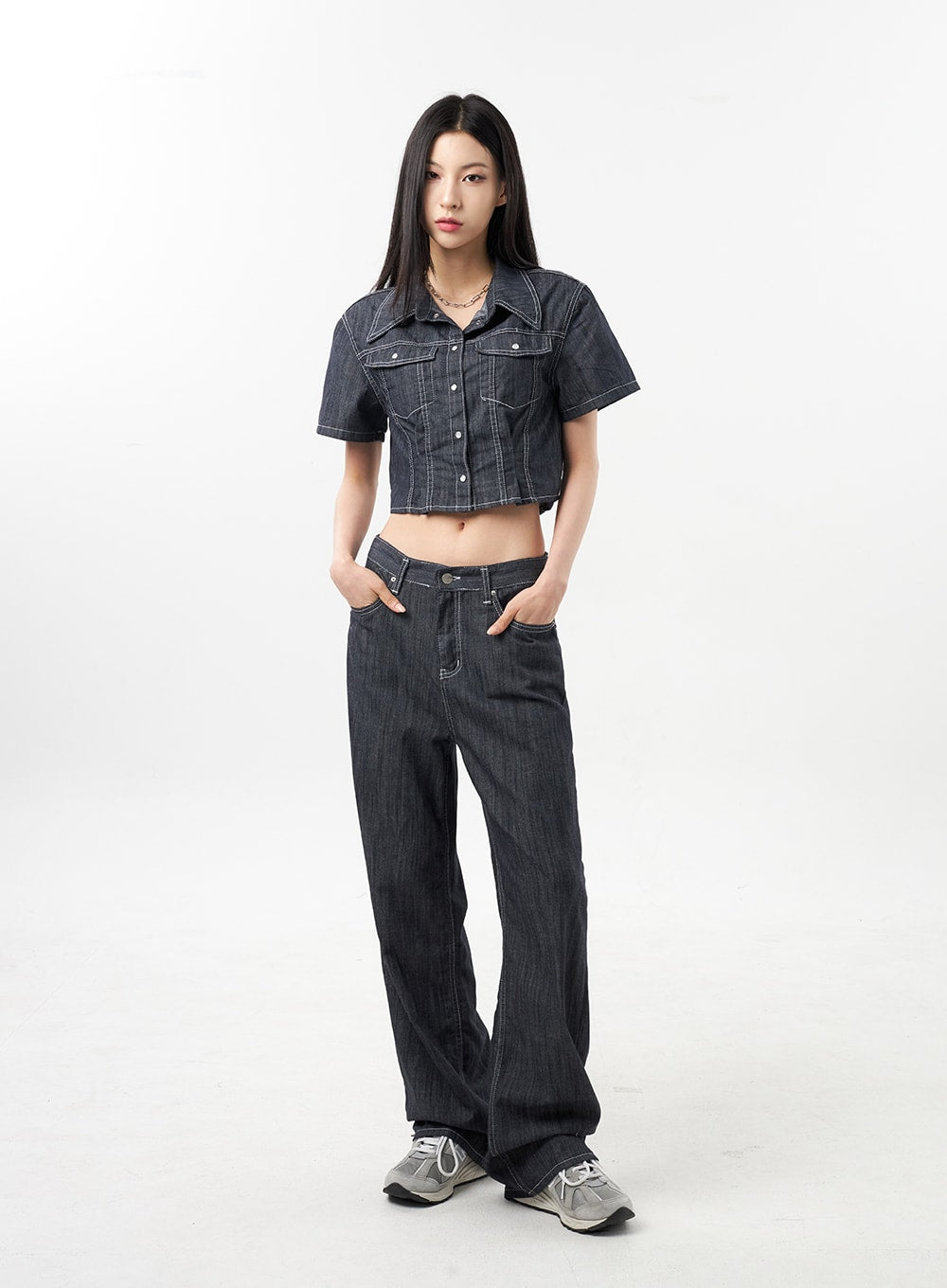 Low Rise Wide Pants CU312 in dark grey, full-length front view on model, hands in pockets pose, low-rise wide-fit street-style denim paired with crop denim jacket and grey sneakers.