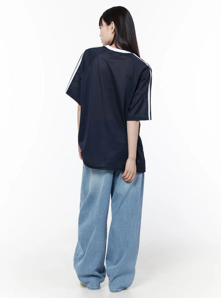 Nella Wide Leg Jeans CU519 in blue, back full-body styled shot on model, light-wash wide leg denim pooling at hem, paired with navy graphic tee, white sneakers.