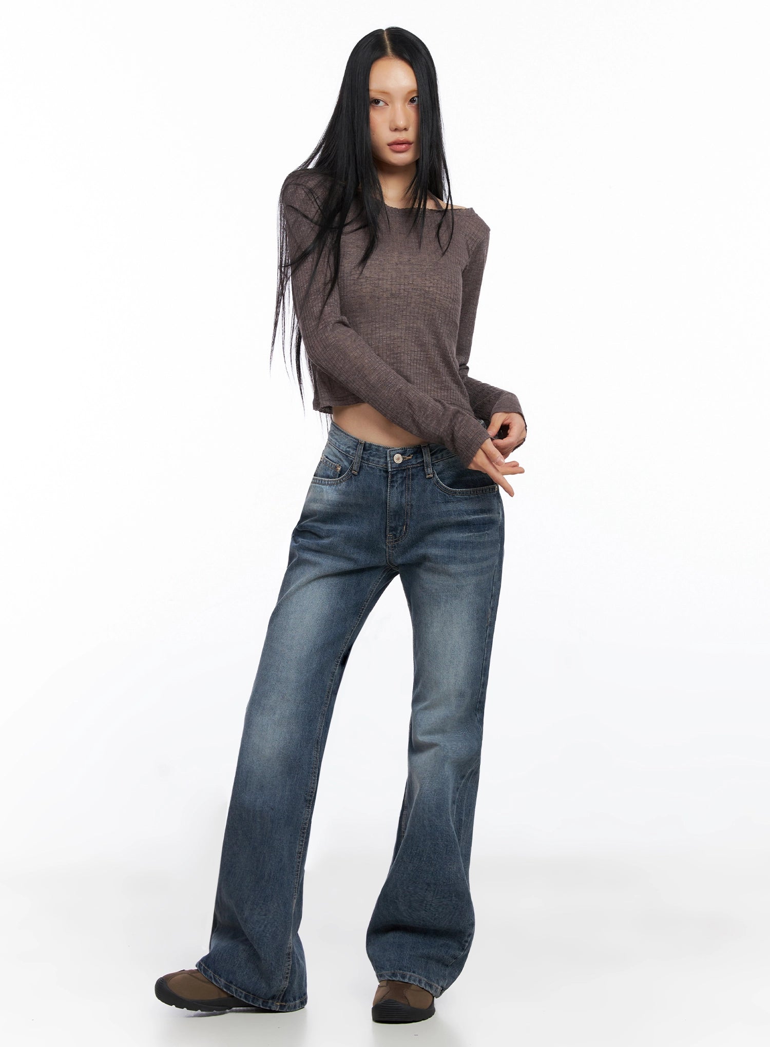 Myra Washed Bootcut Jeans IO516 in dark blue, three-quarter front view on model, full-length outfit shot paired with brown off-shoulder crop knit top and brown flat shoes.