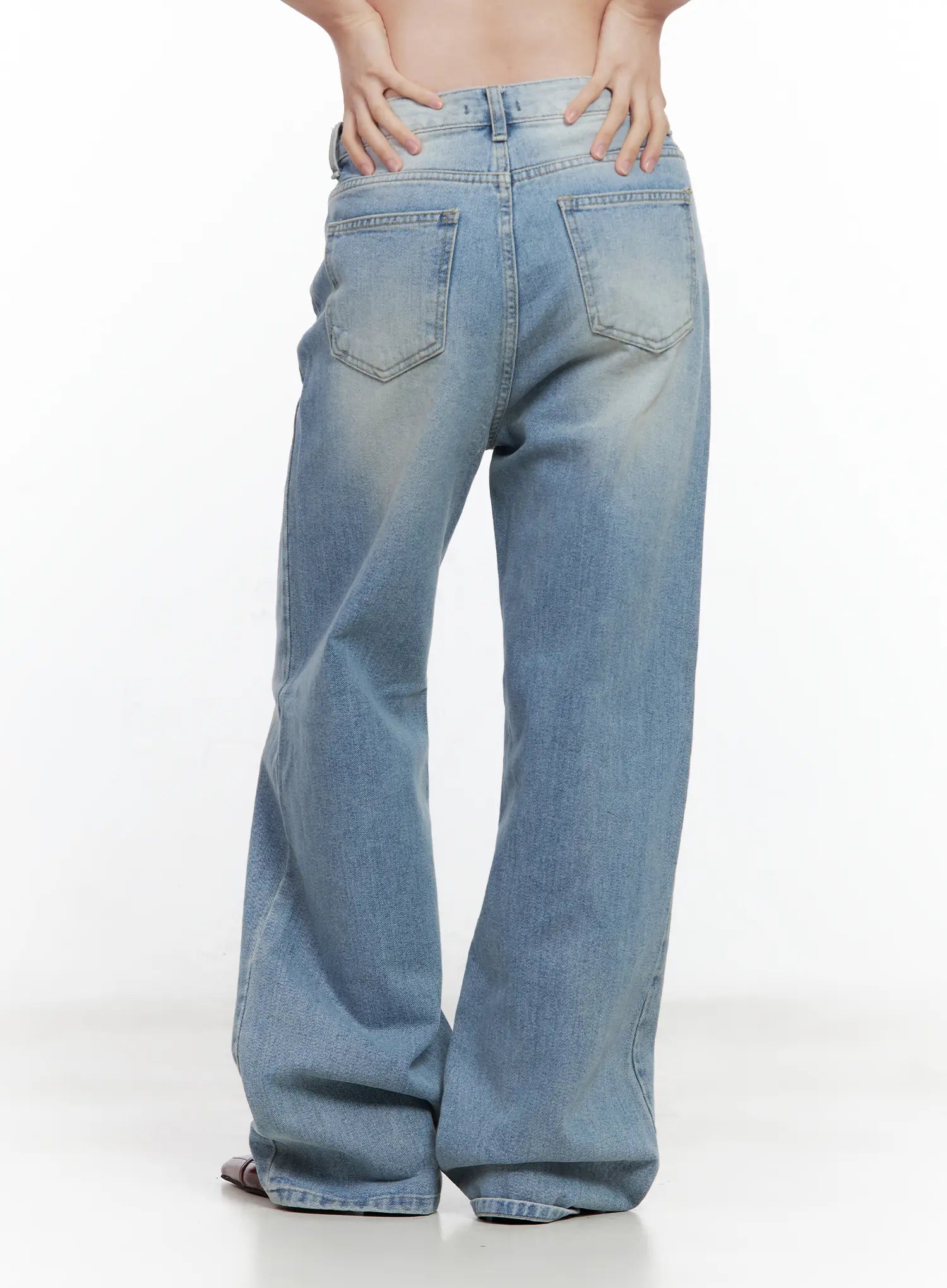 Ina Slouchy Fit Jeans CL502 in blue, back close-up on model, washed denim showing dual back pockets with topstitching, wide-leg hem pooling at floor, subtle whiskering detail.