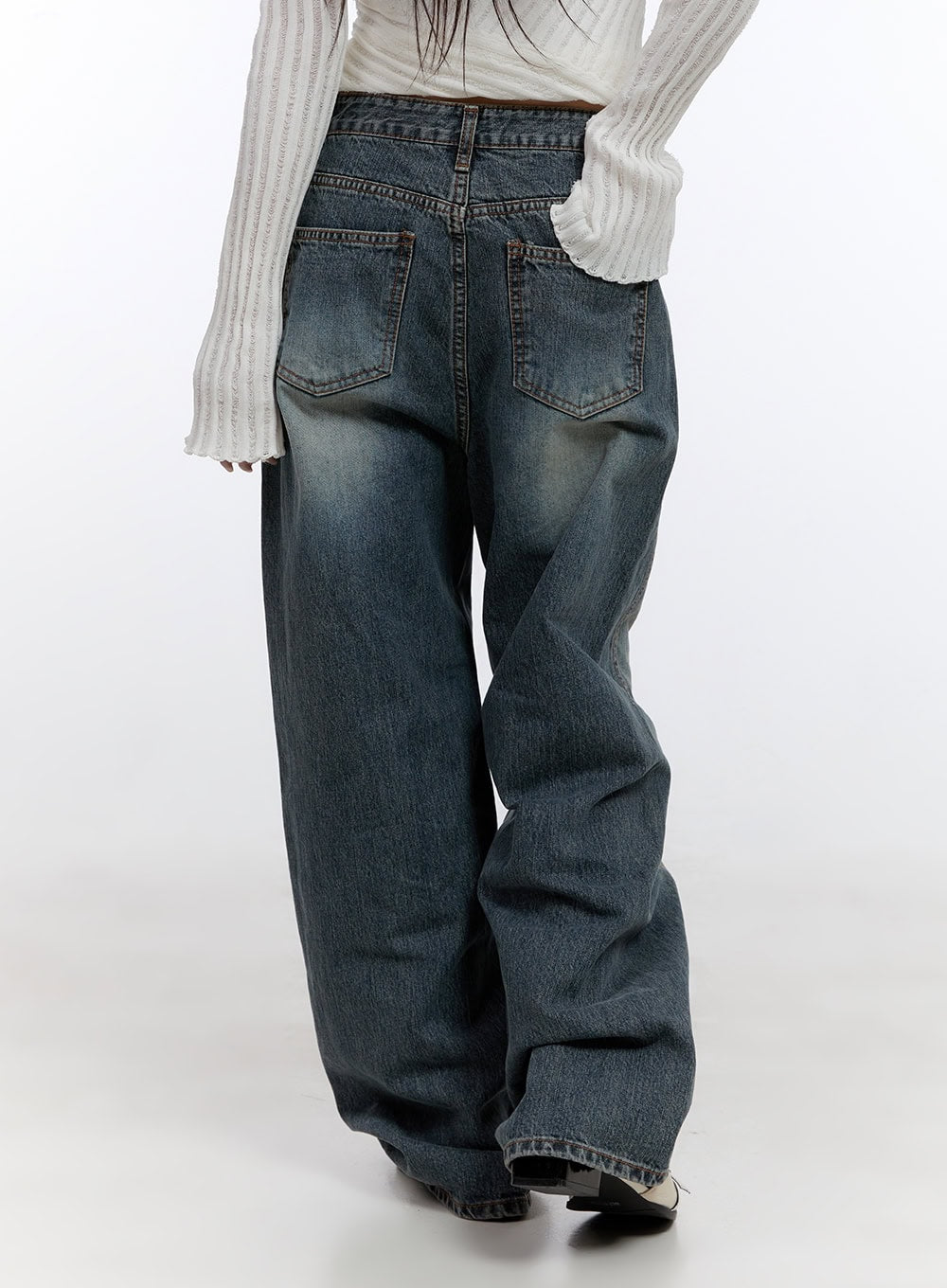Lucia Stitched Denim Baggy Jeans CO418 in blue, back three-quarter close-up on model, showing dual back pockets with contrast stitch, vintage-washed indigo denim and voluminous wide leg.