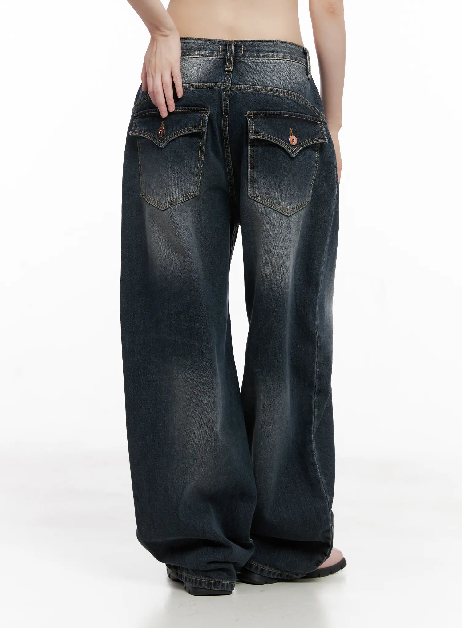 Celi Vintage Wash Wide-Leg Jeans CG515 in dark vintage wash, back three-quarter view on model, flap back pockets with logo hardware visible, wide-leg hem pooling at ankle.