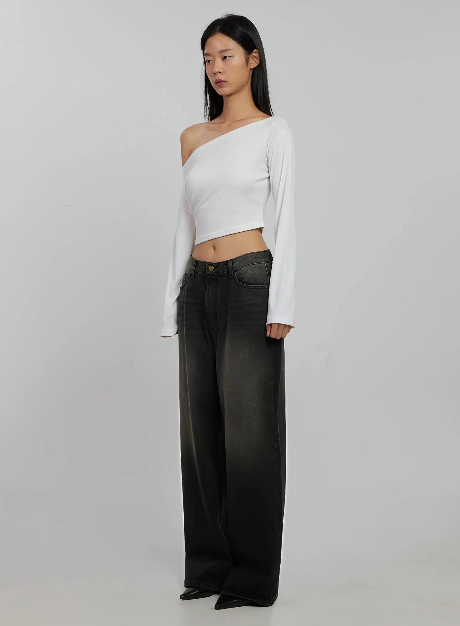 Blaire Dark Washed Wide Leg Jeans IJ509 in black, three-quarter front angle shot on model, dark washed wide leg silhouette paired with white off-shoulder crop top, showing leg volume and faded wash.