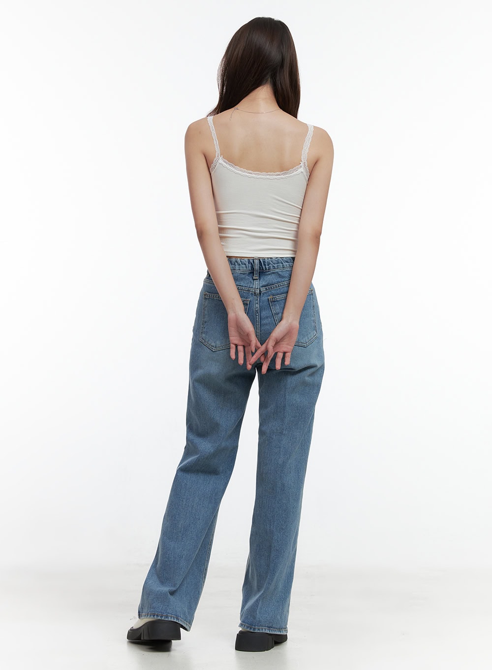 Aubrey Washed Classic Straight-Fit Jeans OO421 in blue, back full view on model, washed denim with dual back pockets and straight wide-leg silhouette, styled with white lace cami top, black loafers.