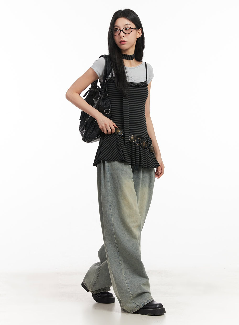 Hillary Washed Wide-Leg Jeans CM504 in light blue, front full-body editorial shot on model walking, layered with striped ruffle top, grey tee, belt bag, and black backpack.