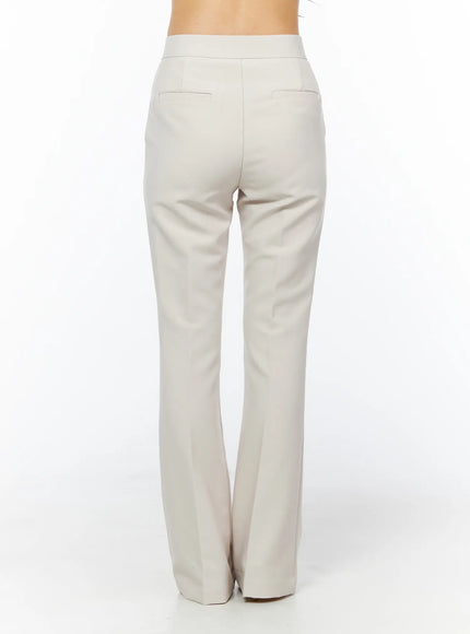 High-Waist Stretch Flared Slacks CU522 in light beige, back full-length product-focused shot, wide high waistband, welt pockets, clean flared leg from hip to hem.