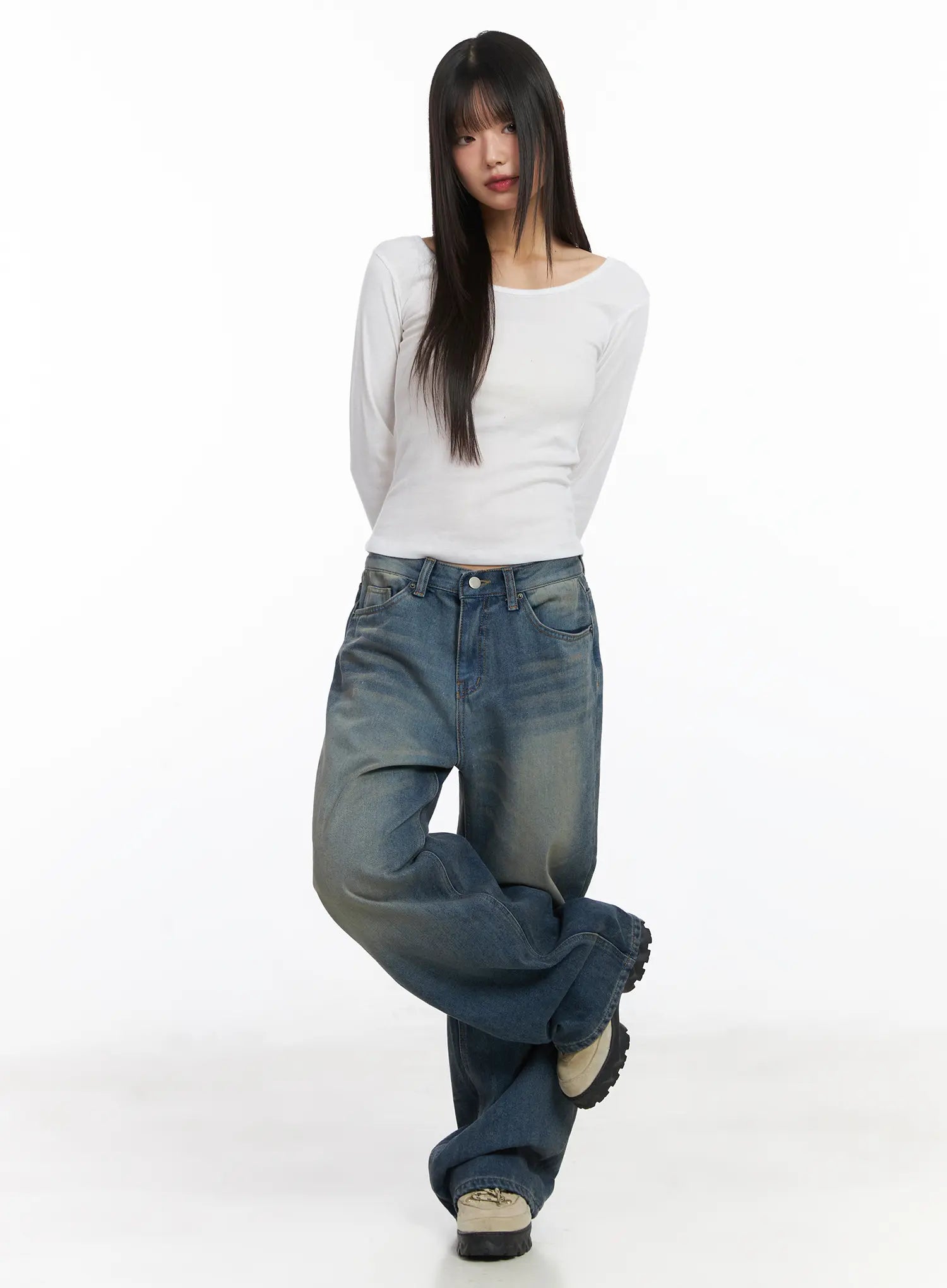 Miriam Wide Leg Jeans CD519 in blue, front full-length on model in relaxed pose, paired with fitted white long-sleeve top, washed wide-leg denim pooling over sneakers.